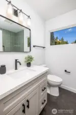 Second bedroom ensuite bathroom with heated floors and extensive tile and thoughtful design.