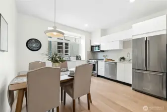 Open kitchen with generous eating area lit by a Portuguese ceramic table lamp.