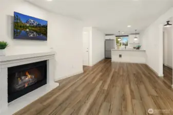 Living room with dining and kitchen - one big space. LVP floors. This is the look from the deck/balcony.