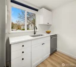 Newly painted kitchen kabinets bright and open, plus new dishwasher and tons of light.