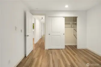 North sided bedroom looking at the closet with convenient shelves/rack inside. Beautiful white sliding closet doors.
