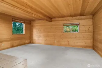 Studio-style living includes one open room, 3/4 bathroom, and kitchen. Look at those gorgeous wood details!