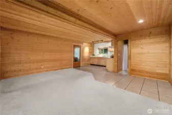 Looking toward the bathroom and kitchen. The front door is to the right of this photo. The glass door straight ahead enters the garage.