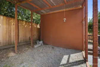 Covered area for wood or gardening soil.