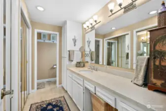 Primary ensuite bathroom with slab marble countertops and marble floors