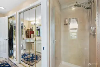 Primary shower with marble tiles and two additional closets