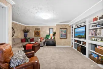 Basement family room with custom built in TV surround