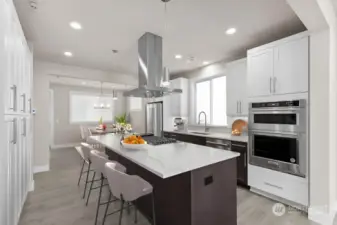 Virtual staging. Thick slab quartz countertops, 5 burner gas range, two tone cabinetry w/ soft close cabinets, and full height tile backsplash!