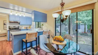 Cozy dining nook just off the kitchen offers direct access to the park-like backyard, ideal for indoor/outdoor living.