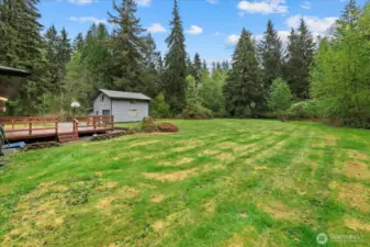 Septic access to the right of the home. Gun shooting backstop to right of cabin to the far E of the yard.