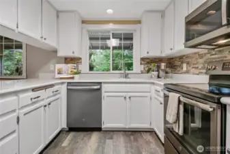 plenty of cabinets plus small pantry behind photogher