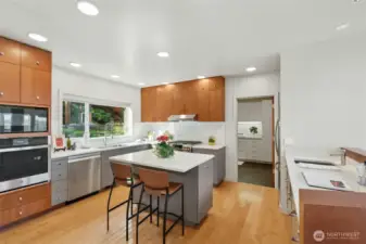 Remodeled kitchen with new counters & designer backsplash, newly painted cabinets, & new stainless steel appliances