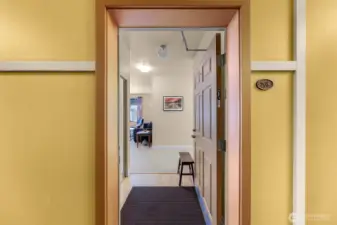 Light and bright entryway with coat closet on left.