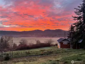 Stunning sunset colors blanket the agricultural land and Sunset Mountain to the southeast.