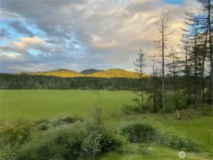 View to the southeast, sunset color on Sunset Mountain. The view is "ever changing" with the seasons, sun and moon.