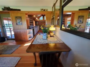 Dining area looks into the kitchen and out to covered porch and patio area.
