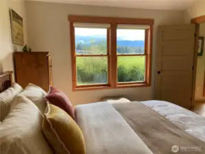 Guest bedroom looks over the open space farm land and Mount Constitution to the Northeast.