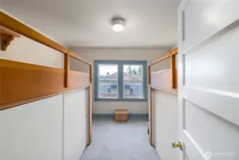 The bunkroom comes with platform beds and storage/closets below.
