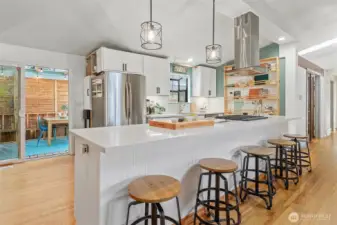 All quartz center island with plenty of eating/entertainment space. Sliders that access covered outdoor space.