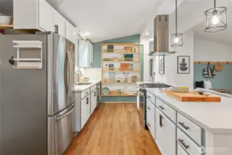 Kitchen view with hardwoods, vaults, recessed lighting and abundance of cabinet space.