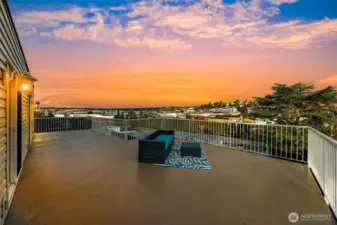 Spacious exterior deck, approximately 515 sq. ft., facing north.