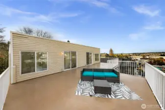 Spacious exterior deck, approximately 515 sq. ft., facing north.