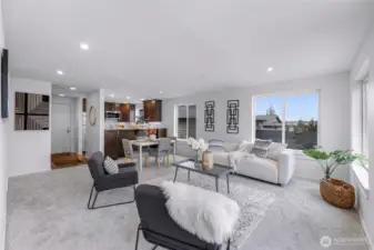 Open living and dining area with seamless deck access.