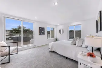 Primary bedroom with walk-in closet, ensuite bath, and direct deck access.