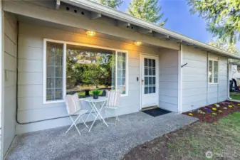 The covered front patio creates an inviting first impression and sets a relaxed tone before you even step inside. There’s enough space here for a small bistro set, making it ideal for morning coffee, evening unwinding or simply enjoying some fresh air while staying protected from the elements. The siding and exterior finishes feel clean and well-maintained, while the sliding glass door brings in natural light and provides easy indoor-outdoor flow. It’s a simple feature, but one that adds everyday livability — a spot you’ll actually use rather than just walk past. The covered aspect also keeps the entry dry year-round, which is a practical bonus in the Pacific Northwest climate.