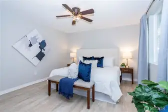 From this angle, the bedroom’s layout flexibility really stands out. The wall space allows for dressers, media setups or additional seating, while maintaining open circulation around the bed. The window placement keeps the room bright without overwhelming it with direct glare. Updated finishes continue the home’s cohesive feel, and the fan overhead reinforces year-round comfort. It’s a simple, functional primary suite that prioritizes livability and ease.