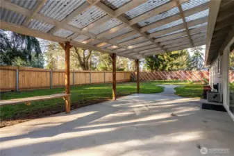 The covered rear patio expands the home’s living space outdoors, creating a year-round usable area for entertaining or relaxing. The overhead structure provides protection from rain and sun, making it ideal for outdoor dining setups, lounge furniture or weekend gatherings. The concrete slab offers low-maintenance durability, and the open yard beyond keeps the space feeling expansive rather than enclosed. It’s a functional extension of the home that enhances everyday usability.