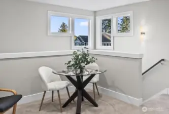 The corner windows bring abundant light in throughout the day, and in the evenings you can see the glow over the partial view of Mt. Rainier.  An often overlooked feature is the overall elevation of The Heritage.  Rather than nestled down in the woods, it is perched above the surrounding area maximizing the natural light at all hours of the day.