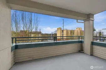 Corner balcony overlooks the not-too busy street