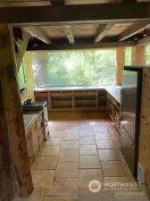 wall of windows in kitchen makes it feel like you are in a tree house!