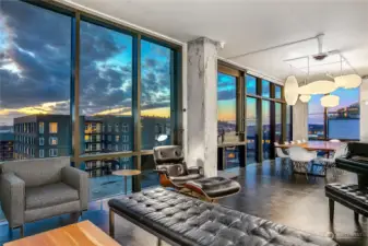 Large, gracious dining area with views through concrete, custom steel, and floor-to-ceiling glass. West-facing windows have IR-reflecting film and tint.