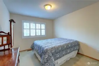 Another look at the bedroom with large windows and shutters