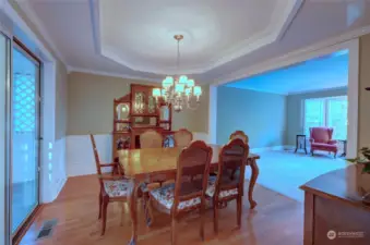 Note the beautiful chandelier, wainscoting and ornate ceiling in the dining room