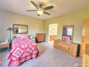 Primary bedroom w/ walk-in closet and large bath.