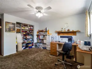 The second bedroom (here used as a craft room) also has a built in desk.