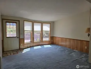 Living room with view of large deck & hillside.