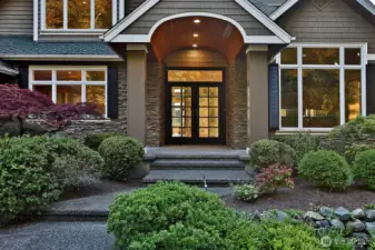 The grand entrance is  highlighted by dramatic gabled rooflines and  expansive windows that invite abundant  natural light.