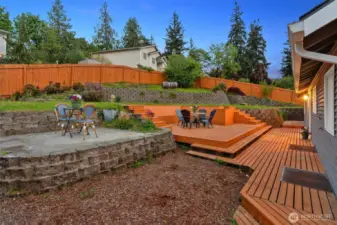 Backyard is nicely scaped and is perfect for entertaining! Large deck and patio. Door from the dining room and door from the kitchen lead to the deck.
