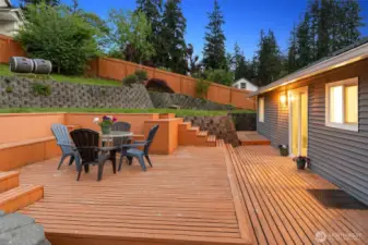 Backyard is nicely scaped and is perfect for entertaining! Large deck and patio. Door from the dining room and door from the kitchen lead to the deck.
