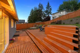 Backyard is nicely scaped and is perfect for entertaining! Large deck and patio. Door from the dining room and door from the kitchen lead to the deck.