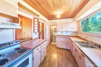 Old school Seaview kitchen, looking west toward the back of the house. Pass through and entrance by stairs on your left. Large window over the sink.