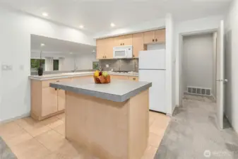 Lower-level full kitchen featuring a center island and gas cooktop.