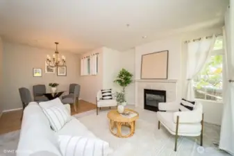 The living room boasts a cozy gas fireplace with a tile surround, perfect for chilly evenings, creating a welcoming atmosphere for relaxation and entertaining.