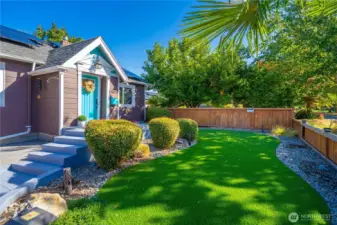 This beautifully landscaped front yard including artificial grass and border landscaping is done and ready for you to move right in and enjoy!