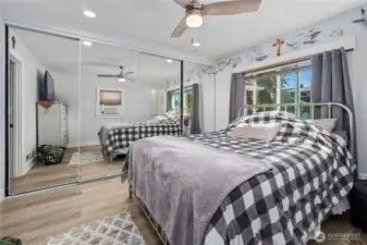Another view of the primary bedroom with the full-length closet space.