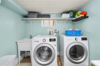 Roomy downstairs laundry room also offers a laundry sink.